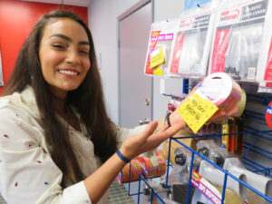 customer at centron self storage holding a piece of tape to be used for packing